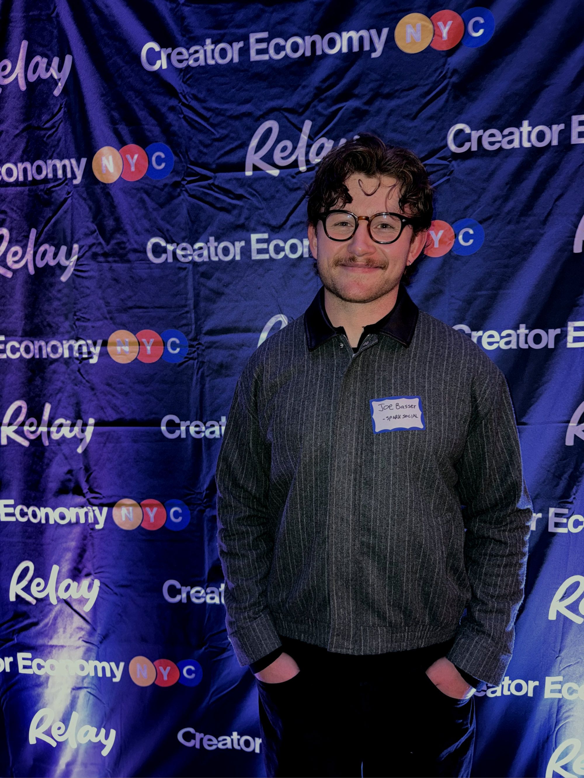 man in front of ‘creator economy nyc’ banner